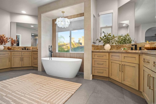 2830 Paradise Ridge Ct, Chula Vista, CA 91915 - bathroom featuring a freestanding bath, two vanities, a chandelier, and concrete floors