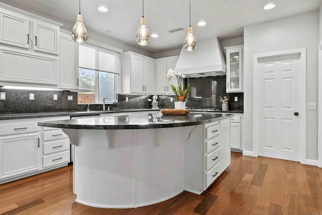 2830 Paradise Ridge Ct, Chula Vista, CA 91915 - kitchen featuring premium range hood, white cabinets, backsplash, a center island, and dark wood-type flooring