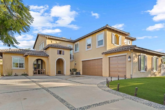 2830 Paradise Ridge Ct, Chula Vista, CA 91915 - mediterranean / spanish-style house with an attached garage, a tiled roof, driveway, stucco siding, and a front lawn