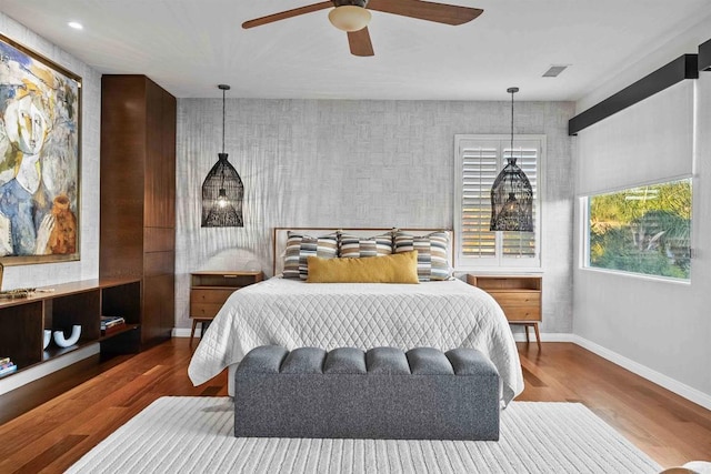 2830 Paradise Ridge Ct, Chula Vista, CA 91915 - bedroom with wood finished floors, wallpapered walls, ceiling fan, and an accent wall