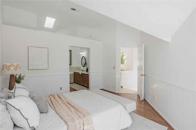 407 Mountain Laurel Ct, Mountain View, CA 94043 - bedroom with wainscoting, a skylight, vaulted ceiling, light wood-style floors, and ensuite bath