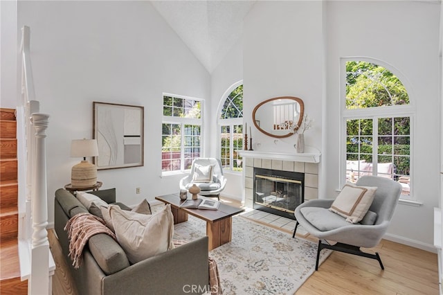 407 Mountain Laurel Ct, Mountain View, CA 94043 - living room featuring high vaulted ceiling, a tiled fireplace, and wood finished floors