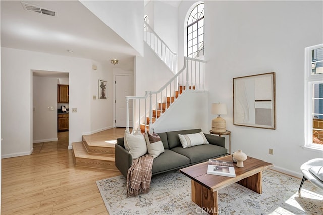 407 Mountain Laurel Ct, Mountain View, CA 94043 - living area featuring stairway, light wood-style flooring, and a high ceiling