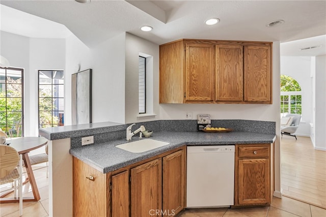 407 Mountain Laurel Ct, Mountain View, CA 94043 - kitchen with white dishwasher, dark countertops, brown cabinetry, a peninsula, and recessed lighting