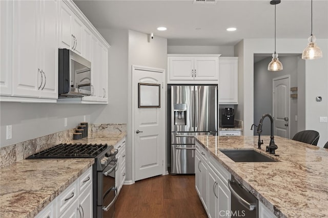 531 Owens River Dr, Oxnard, CA 93036 - kitchen featuring appliances with stainless steel finishes, white cabinetry, dark wood-type flooring, recessed lighting, and hanging light fixtures