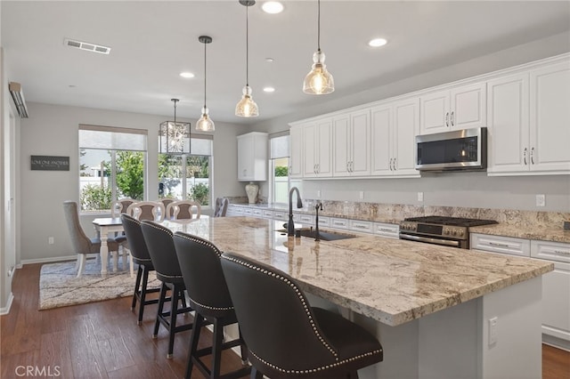 531 Owens River Dr, Oxnard, CA 93036 - kitchen with stainless steel appliances, healthy amount of natural light, dark wood-type flooring, white cabinets, and recessed lighting