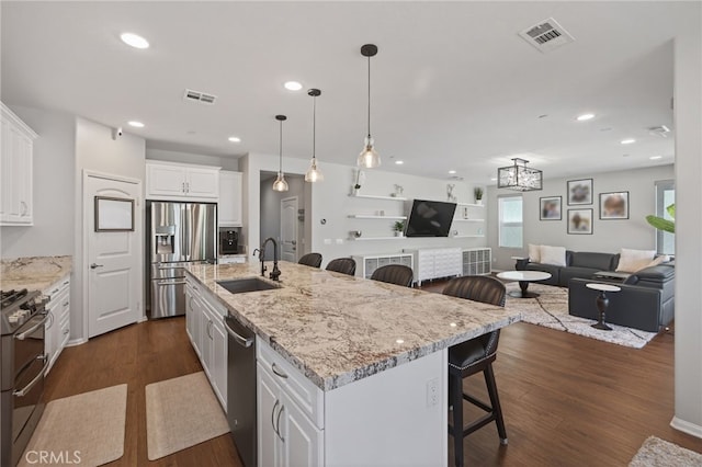 531 Owens River Dr, Oxnard, CA 93036 - kitchen with appliances with stainless steel finishes, a kitchen breakfast bar, plenty of natural light, white cabinets, and recessed lighting
