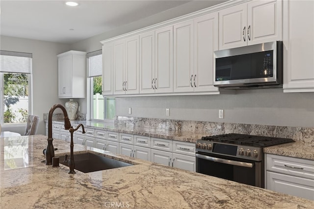531 Owens River Dr, Oxnard, CA 93036 - kitchen with appliances with stainless steel finishes, white cabinetry, plenty of natural light, and recessed lighting
