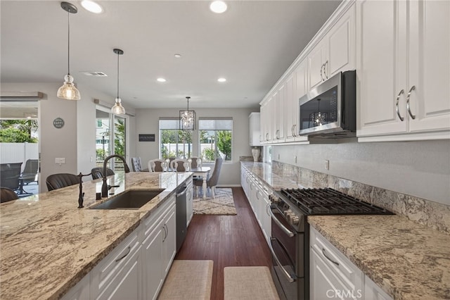 531 Owens River Dr, Oxnard, CA 93036 - kitchen featuring stainless steel appliances, recessed lighting, white cabinets, dark wood-style floors, and light stone counters