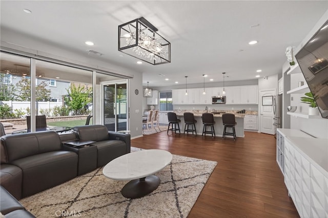 531 Owens River Dr, Oxnard, CA 93036 - living room featuring a chandelier, recessed lighting, and dark wood finished floors
