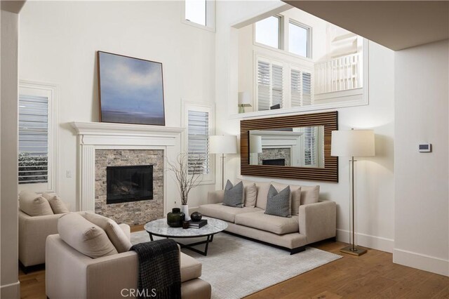 57 Cape Andover, Newport Beach, CA 92660 - living room with a fireplace, a high ceiling, and wood finished floors