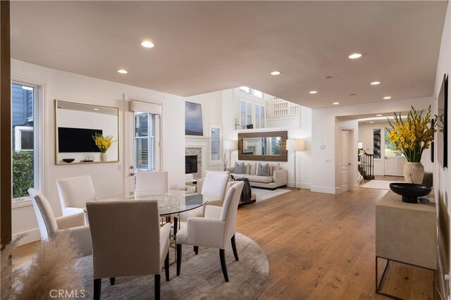 57 Cape Andover, Newport Beach, CA 92660 - dining space featuring light wood-style flooring, recessed lighting, and a fireplace
