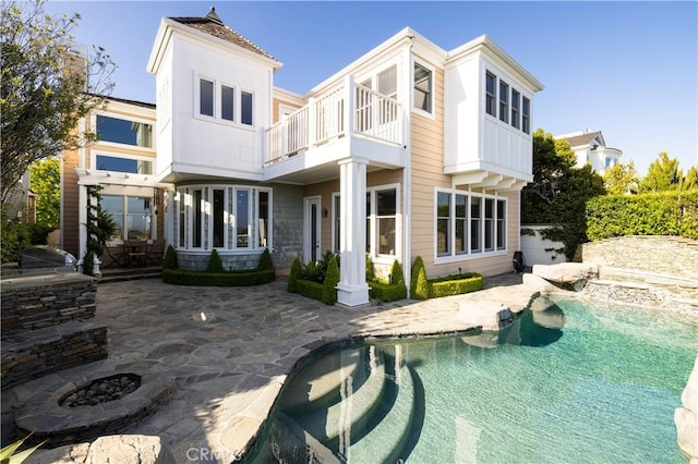 57 Cape Andover, Newport Beach, CA 92660 - rear view of property featuring a balcony, a patio, and an outdoor pool
