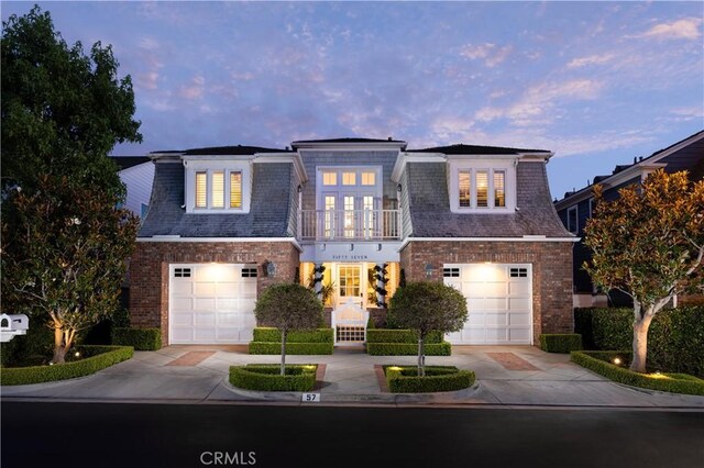 57 Cape Andover, Newport Beach, CA 92660 - view of front of house with french doors, a balcony, concrete driveway, brick siding, and a garage