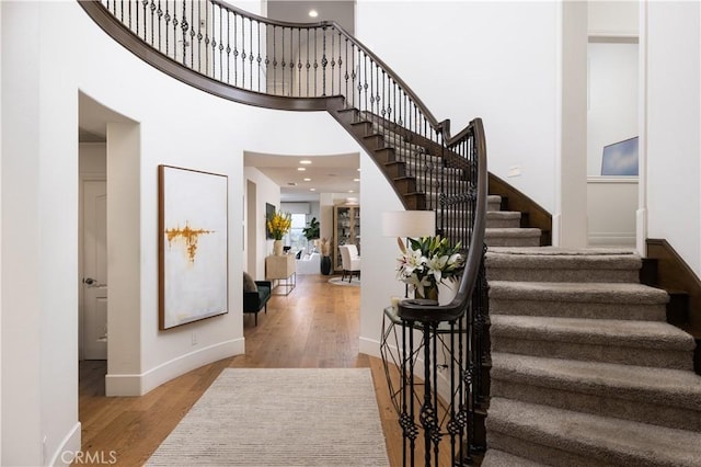 57 Cape Andover, Newport Beach, CA 92660 - foyer with stairs, wood finished floors, a high ceiling, and recessed lighting