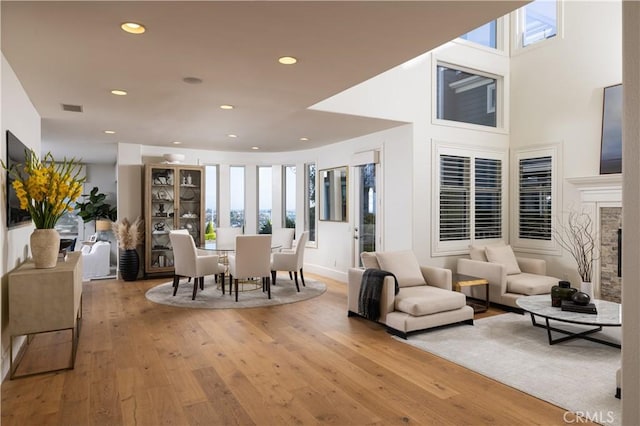 57 Cape Andover, Newport Beach, CA 92660 - dining area featuring light wood-type flooring, recessed lighting, and a fireplace