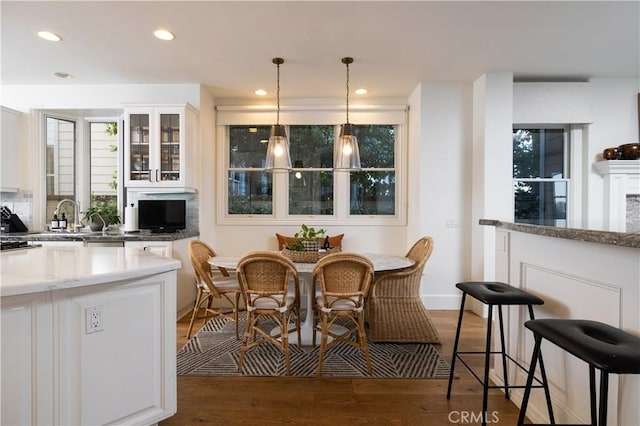 57 Cape Andover, Newport Beach, CA 92660 - kitchen with white cabinets, glass insert cabinets, light wood-style floors, recessed lighting, and hanging light fixtures