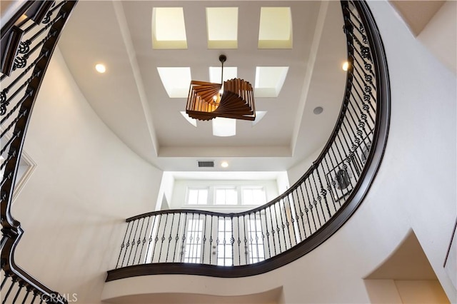 57 Cape Andover, Newport Beach, CA 92660 - staircase with a high ceiling, a skylight, a raised ceiling, and recessed lighting