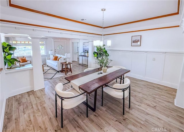 4216 Dalton Ave, Los Angeles, CA 90062 - dining room with a decorative wall, light wood-type flooring, wainscoting, and a raised ceiling
