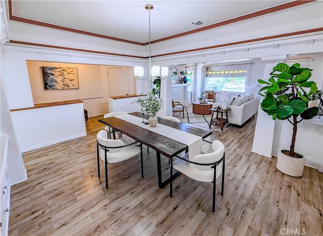 4216 Dalton Ave, Los Angeles, CA 90062 - dining area featuring light wood-type flooring and ornamental molding