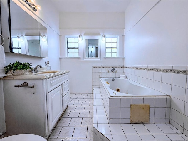 4216 Dalton Ave, Los Angeles, CA 90062 - bathroom with a tub with jets, vanity, and tile patterned floors