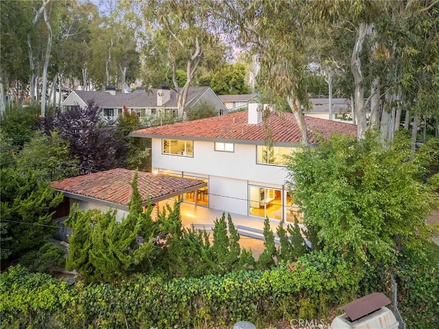 105 Via Capay, Palos Verdes Estates, CA 90274 - rear view of property featuring stucco siding and view of scattered trees