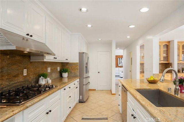 105 Via Capay, Palos Verdes Estates, CA 90274 - kitchen with appliances with stainless steel finishes, light tile patterned flooring, under cabinet range hood, tasteful backsplash, and white cabinetry