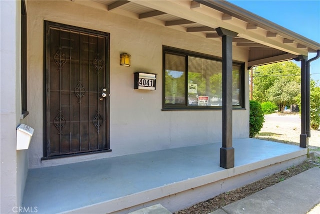 4041 57th St, Sacramento, CA 95820 - doorway to property with covered porch and stucco siding