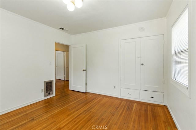 4041 57th St, Sacramento, CA 95820 - unfurnished bedroom featuring light wood-type flooring, crown molding, and a closet