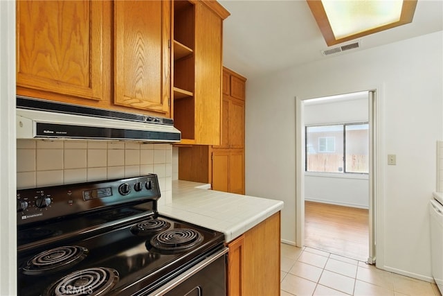 4041 57th St, Sacramento, CA 95820 - kitchen with black electric range oven, extractor fan, tile countertops, open shelves, and decorative backsplash