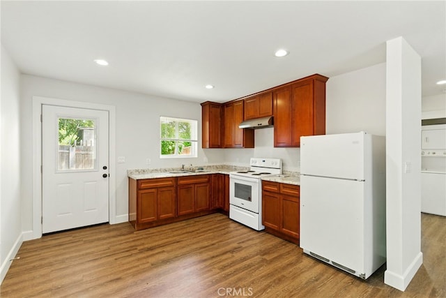 4041 57th St, Sacramento, CA 95820 - kitchen featuring white appliances, under cabinet range hood, light wood finished floors, recessed lighting, and light stone counters