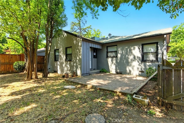 4041 57th St, Sacramento, CA 95820 - back of property featuring board and batten siding and a patio