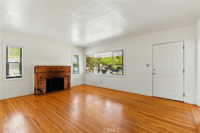 4041 57th St, Sacramento, CA 95820 - unfurnished living room with plenty of natural light, light wood-style floors, and a fireplace