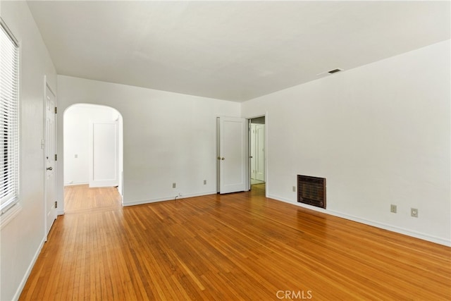 4041 57th St, Sacramento, CA 95820 - unfurnished living room featuring wood finished floors, arched walkways, and a fireplace