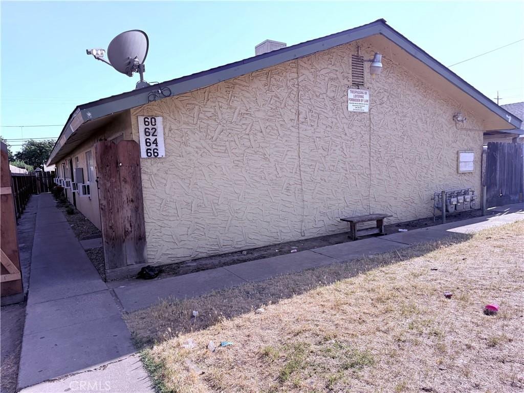60 E 12th St, Merced, CA 95341 - view of side of home featuring stucco siding