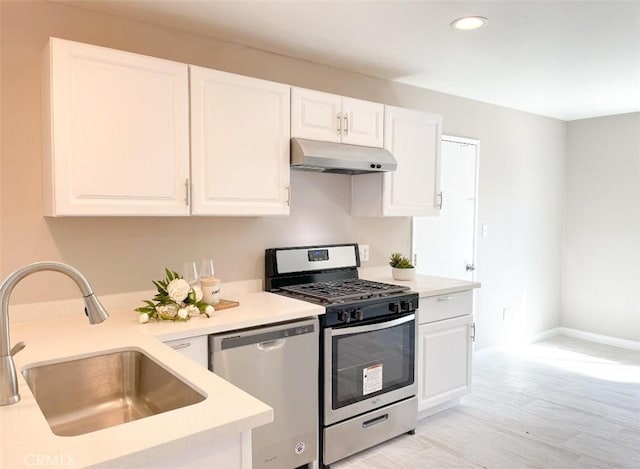429 N Peg St, Ridgecrest, CA 93555 - kitchen featuring stainless steel appliances, under cabinet range hood, light countertops, white cabinetry, and recessed lighting
