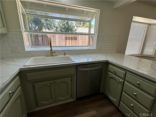 899 La Jolla Way, Merced, CA 95348 - kitchen featuring stainless steel dishwasher, backsplash, dark wood-style flooring, and light stone countertops
