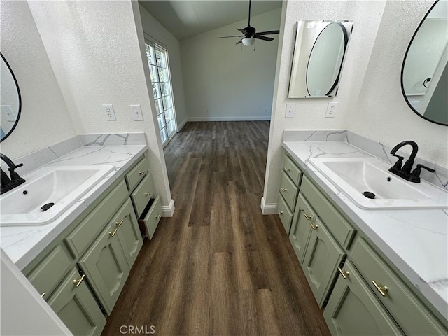899 La Jolla Way, Merced, CA 95348 - bathroom featuring wood finished floors, two vanities, lofted ceiling, a ceiling fan, and a textured wall