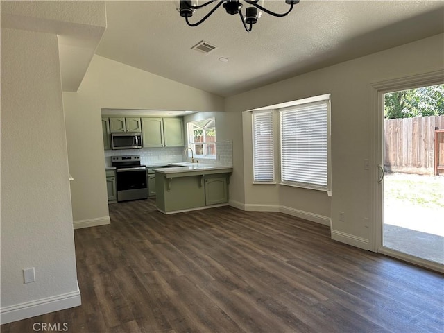 899 La Jolla Way, Merced, CA 95348 - kitchen with stainless steel appliances, green cabinets, a chandelier, a peninsula, and dark wood-type flooring
