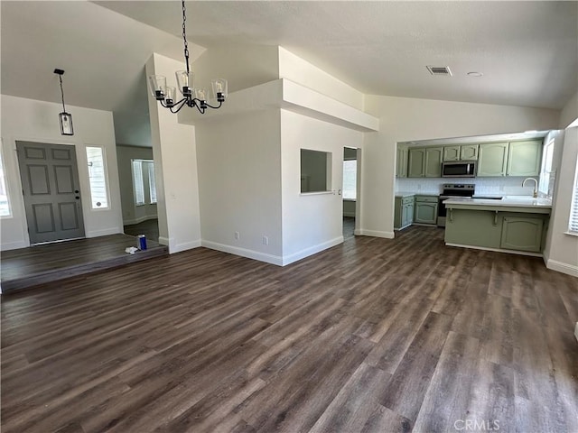 899 La Jolla Way, Merced, CA 95348 - unfurnished living room featuring a chandelier, high vaulted ceiling, and dark wood-style flooring