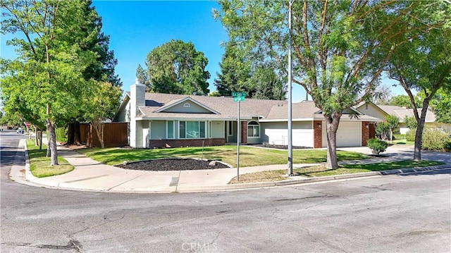 899 La Jolla Way, Merced, CA 95348 - ranch-style home featuring brick siding, driveway, an attached garage, and a chimney