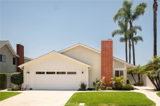 4313 Sea Bright Dr, Carlsbad, CA 92008 - view of front facade featuring an attached garage, concrete driveway, a front yard, a chimney, and board and batten siding