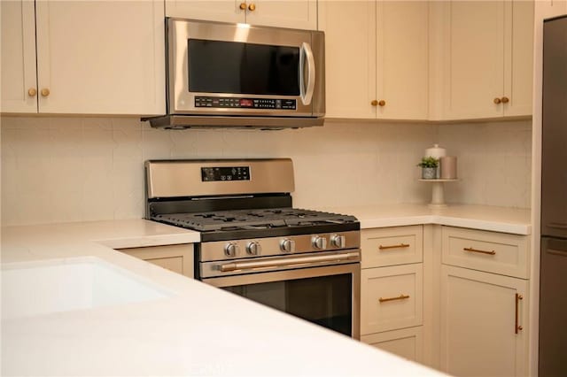 4313 Sea Bright Dr, Carlsbad, CA 92008 - kitchen with appliances with stainless steel finishes, tasteful backsplash, and light countertops