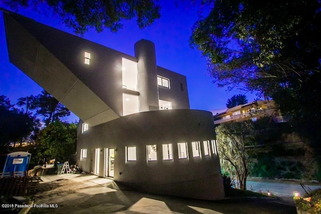 940 Burleigh Dr, Pasadena, CA 91105 - property exterior at night with a patio area and stucco siding