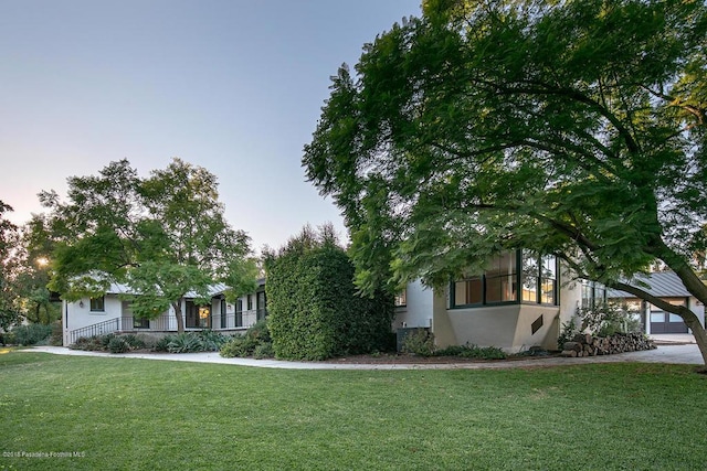 1425 Wentworth Ave, Pasadena, CA 91106 - obstructed view of property with a front yard, stucco siding, and covered porch