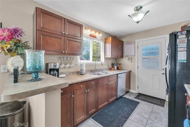 195 Morristown Ln, Costa Mesa, CA 92626 - kitchen with dishwasher, freestanding refrigerator, light countertops, and light tile patterned floors