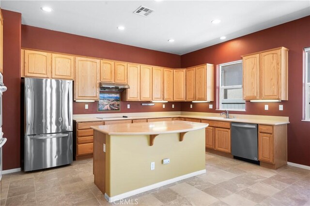 1706 Brittney Rd, Beaumont, CA 92223 - kitchen with appliances with stainless steel finishes, light brown cabinets, a center island, light countertops, and recessed lighting