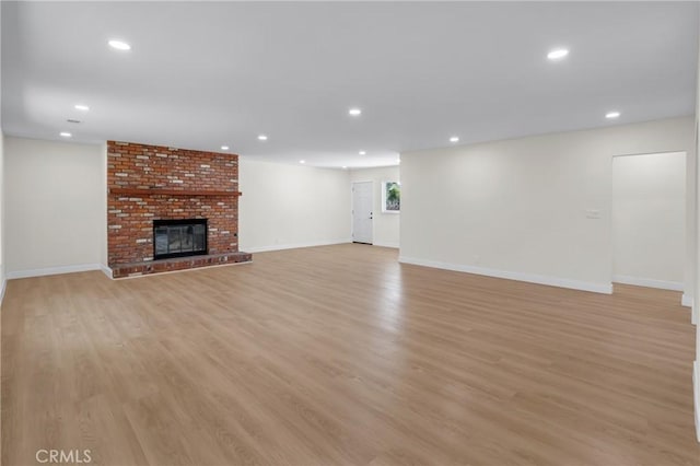 12815 Rexton St, Norwalk, CA 90650 - unfurnished living room featuring recessed lighting, light wood finished floors, and a fireplace