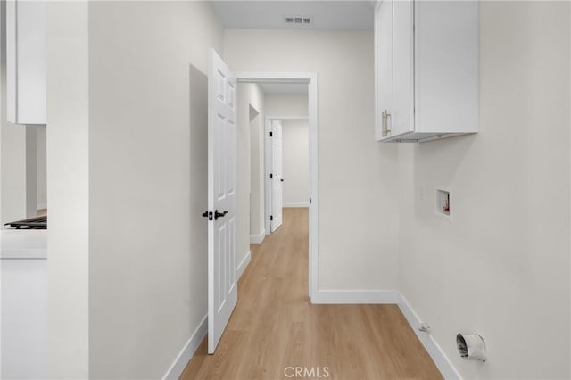 12815 Rexton St, Norwalk, CA 90650 - laundry area featuring cabinet space, washer hookup, and light wood-style floors