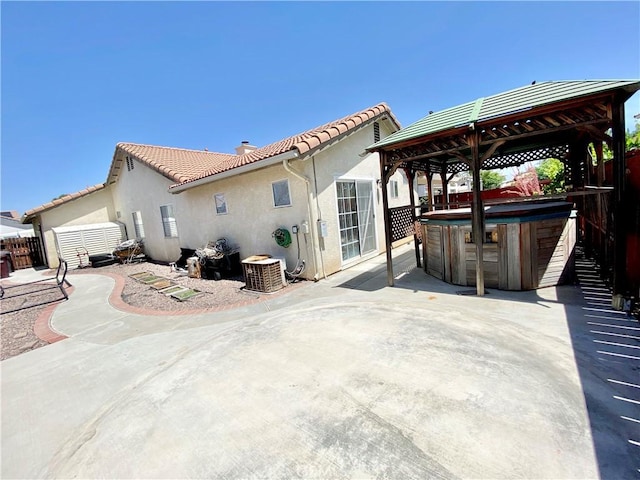 980 Lexington St, Hemet, CA 92545 - back of property featuring a hot tub, a gazebo, a patio area, and stucco siding